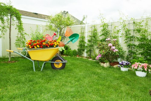 Team preparing lawn mower in a Hornsey garden before mowing